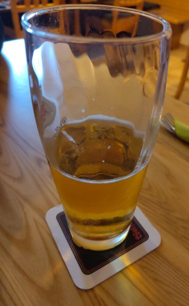 A half empty glass of beer.