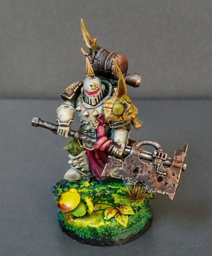 Fully painted miniature of a Death Guard Plague Marine. He's carrying a giant axe.